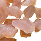 Side-on view of Grade AA Rose Quartz raw stone, associated with Love and Self Love.