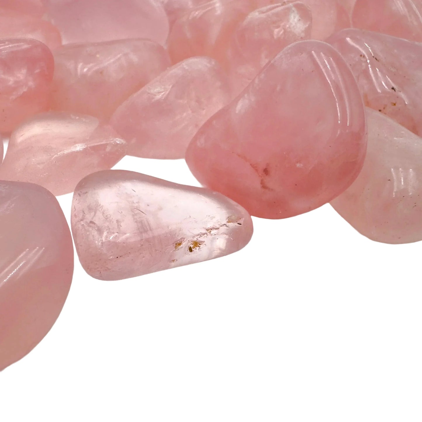 Edge-on view of Rose Quartz tumbled stone, turned to for Love, showing translucent edges.