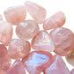 Underside view of pink Rose Quartz tumbled stone, showing earthy tone, drawn on for Love.