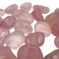 Grade aaa rose quartz tumbled stone held in hand for size reference