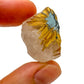 Set against a soft backdrop is a Quartz raw crystal, from Minas Gerais, Brazil, in the warmth of daylight.