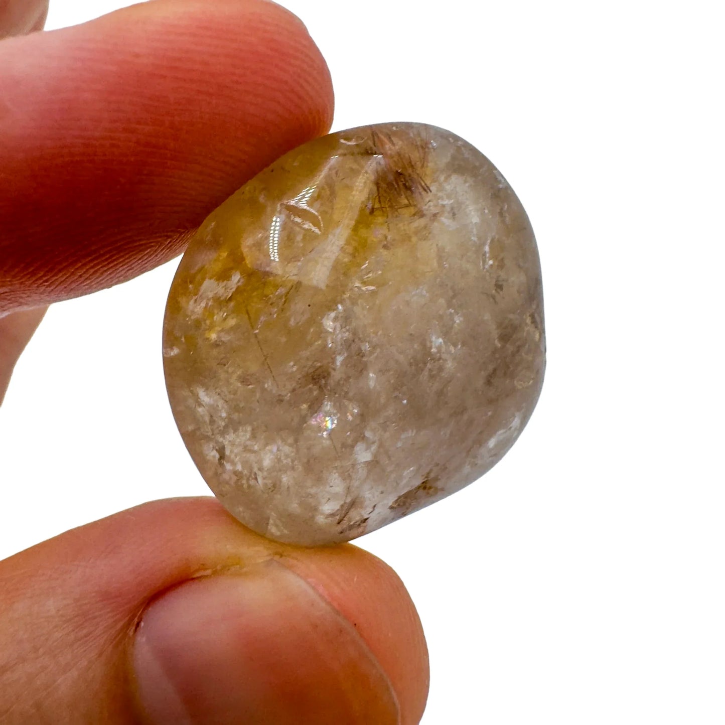 Hand-held view of a Quartz tumbled stone kept close for Cleansing, hand-selected from Minas Gerais, Brazil.
