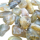 Top-down shot of Quartz tumbled stone, showing natural inclusions.