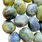 Close-up of Serpentine tumbled stone, drawn on for Healing and Emotional Healing.