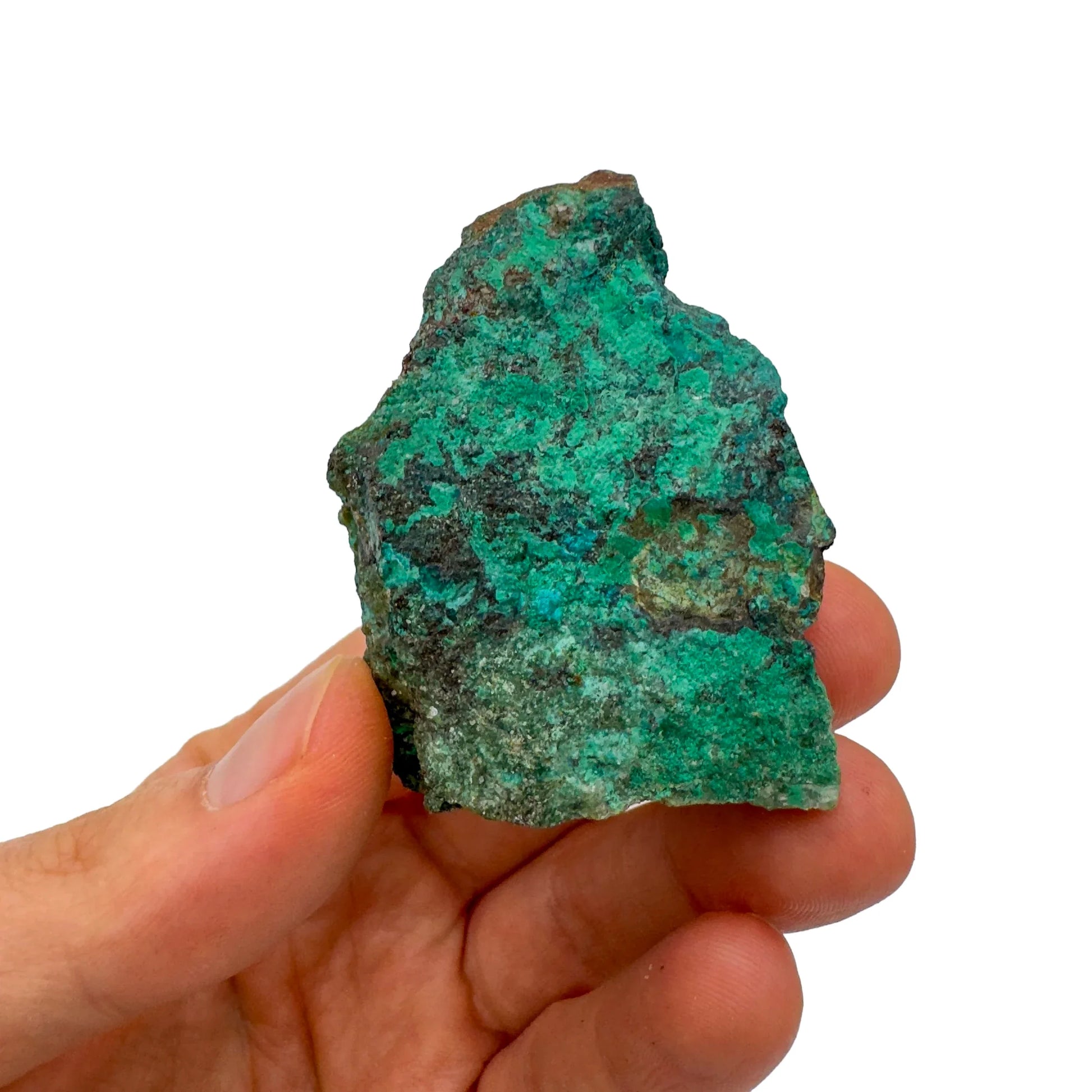 On a soft surface rests a Chrysocolla raw crystal, traditionally used for Emotional Healing, with character of the piece on display.