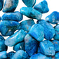 Back view of Chrysocolla tumbled stone, showing characteristic color.