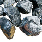 Edge-on view of Shungite raw stone, showing natural inclusions.