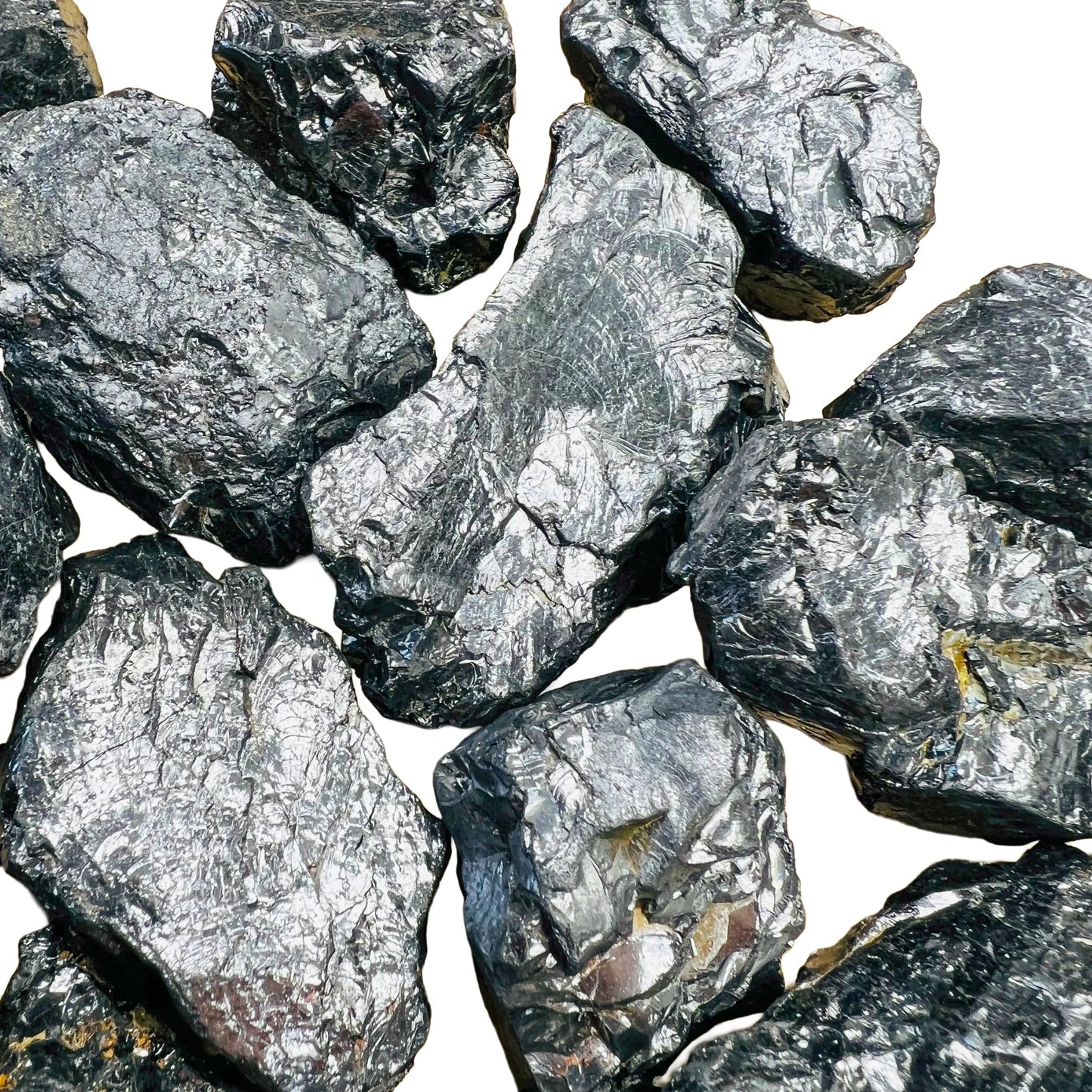 Held in hand, a Shungite raw stone held against natural backdrop, from Russia.