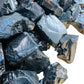 Held in hand, a single Shungite raw stone Russia-sourced.