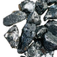 Held in hand, a Shungite raw stone, sourced from Republic of Karélia, Russia.