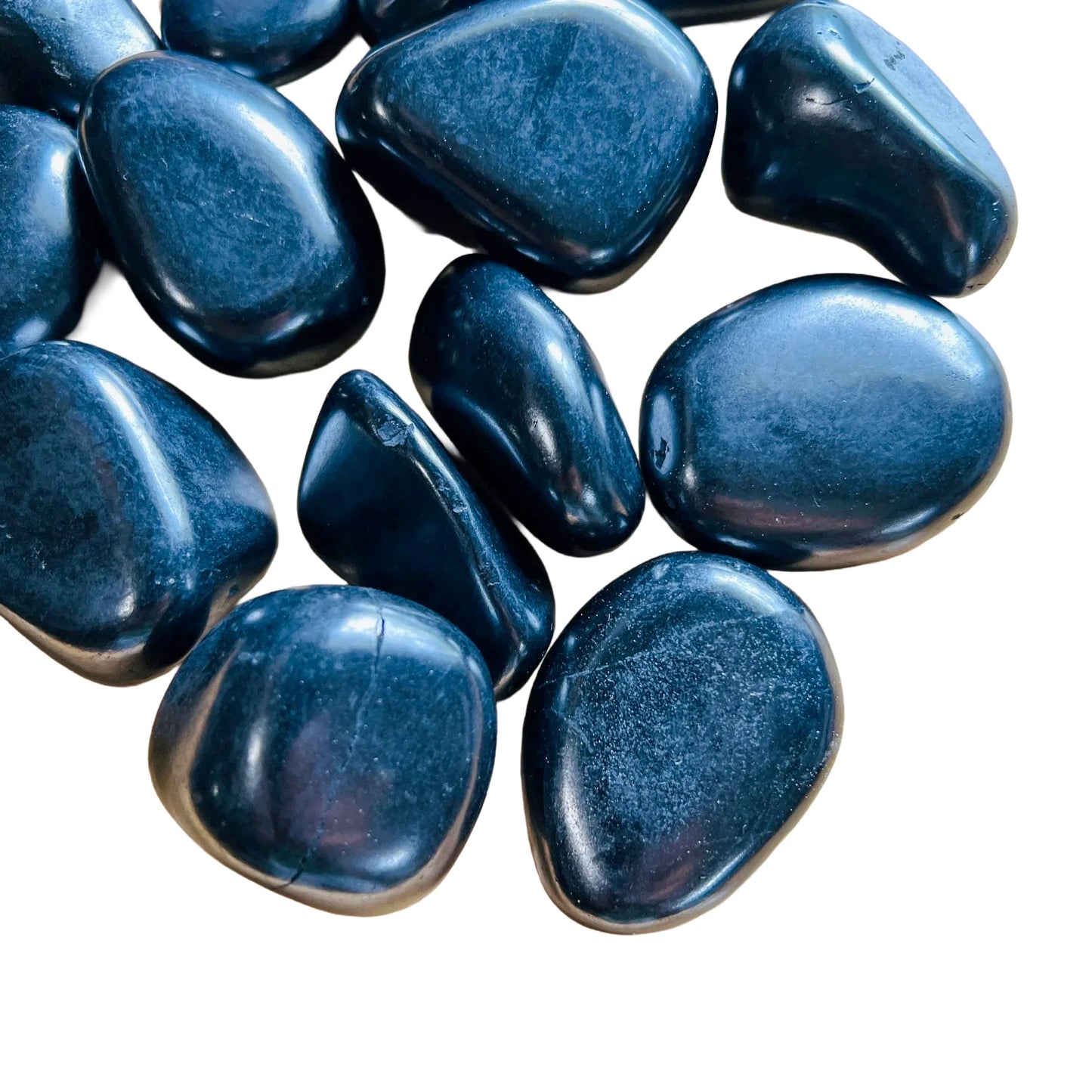 Near view of Shungite tumbled stone, showing natural variation, drawn on for Protection.