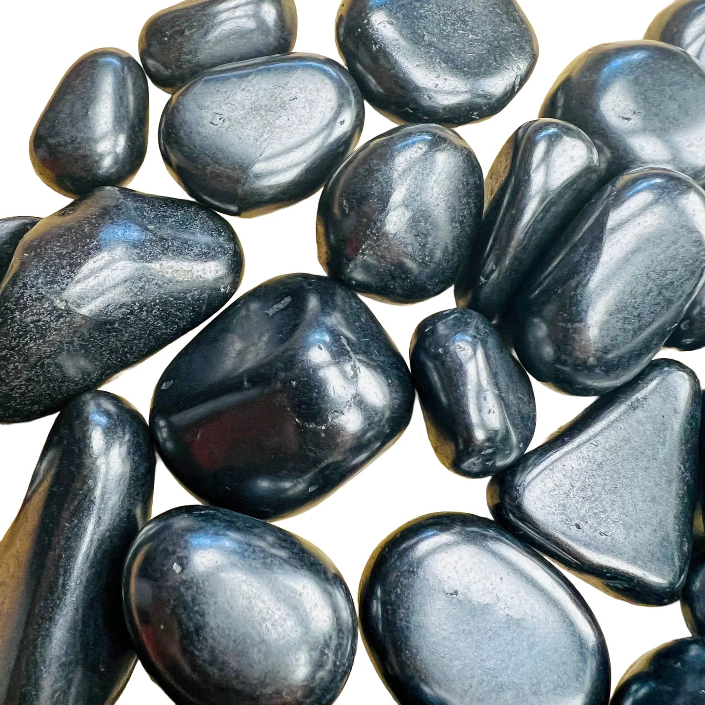 Side-on view of Shungite tumbled stone, to support Protection, showing soft luster.