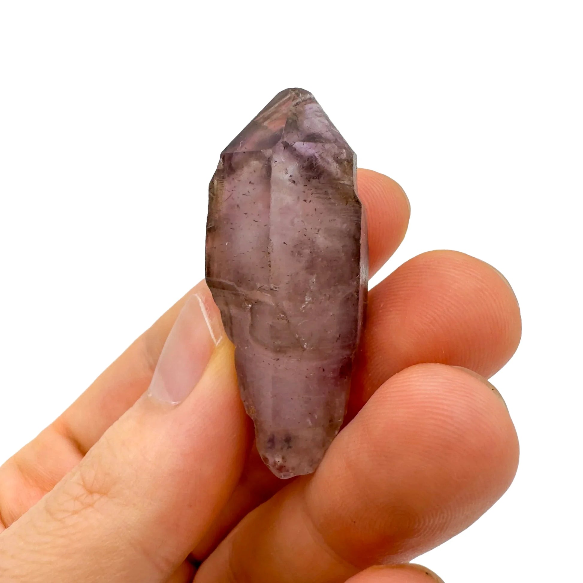 Considered view of Smoky Amethyst raw crystal, from Masvingo, Zimbabwe, shown alongside the hand for scale.