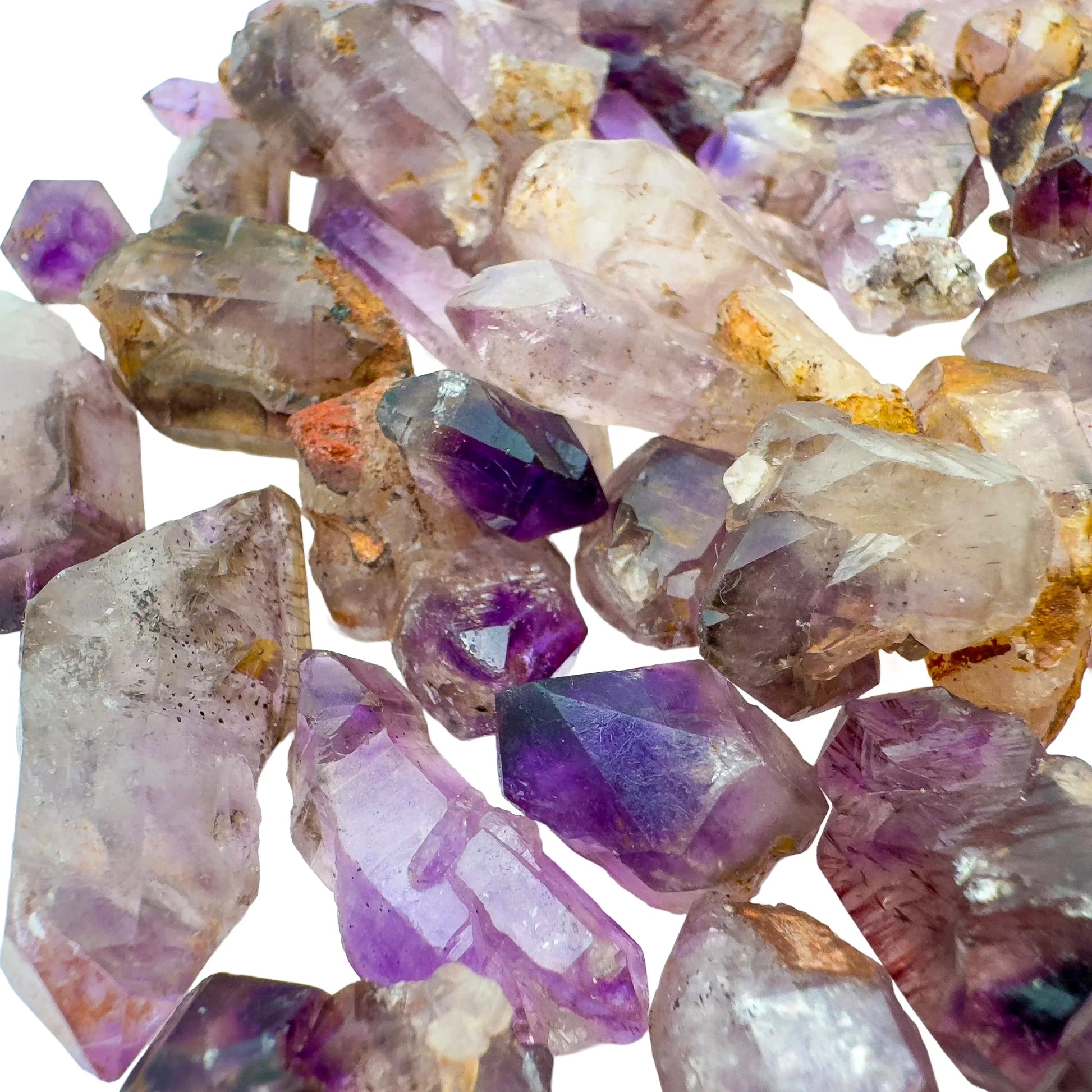 Size comparison with one Smoky Amethyst raw point for scale, Zimbabwe-sourced.
