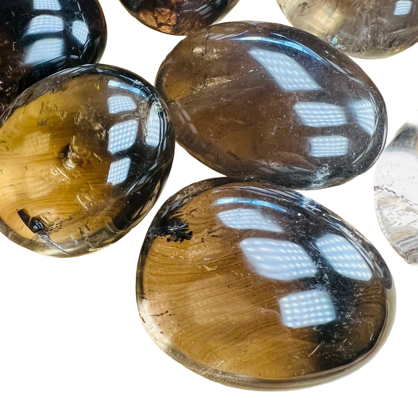 Grain detail of Smoky Quartz palm stone, showing characteristic finish, linked to Grounding.