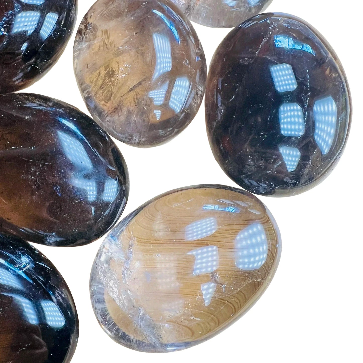 Bird's-eye view of Grade AA Smoky Quartz palm stone, often worked with for Grounding, sourced from Alaotra-Mangoro, Madagascar.
