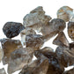 Held against neutral backdrop is a Smoky Quartz raw crystal, from Minas Gerais, Brazil, with subtle natural color showing through.