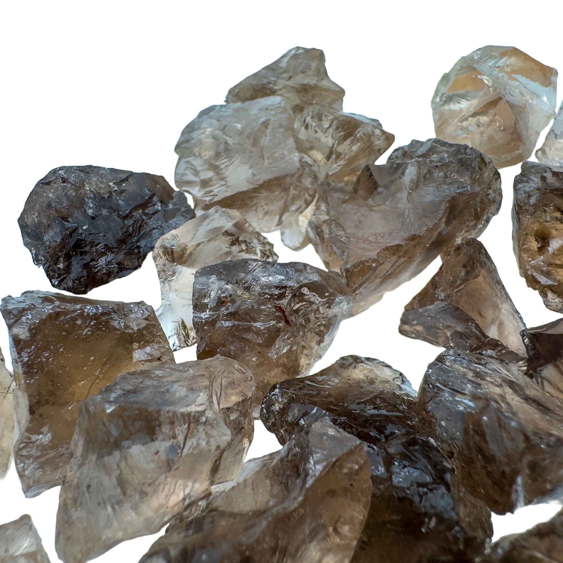 Held against neutral backdrop is a Smoky Quartz raw crystal, from Minas Gerais, Brazil, with subtle natural color showing through.