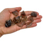 Hand holding small smoky quartz raw crystals 5-10 grams Brazil scale reference