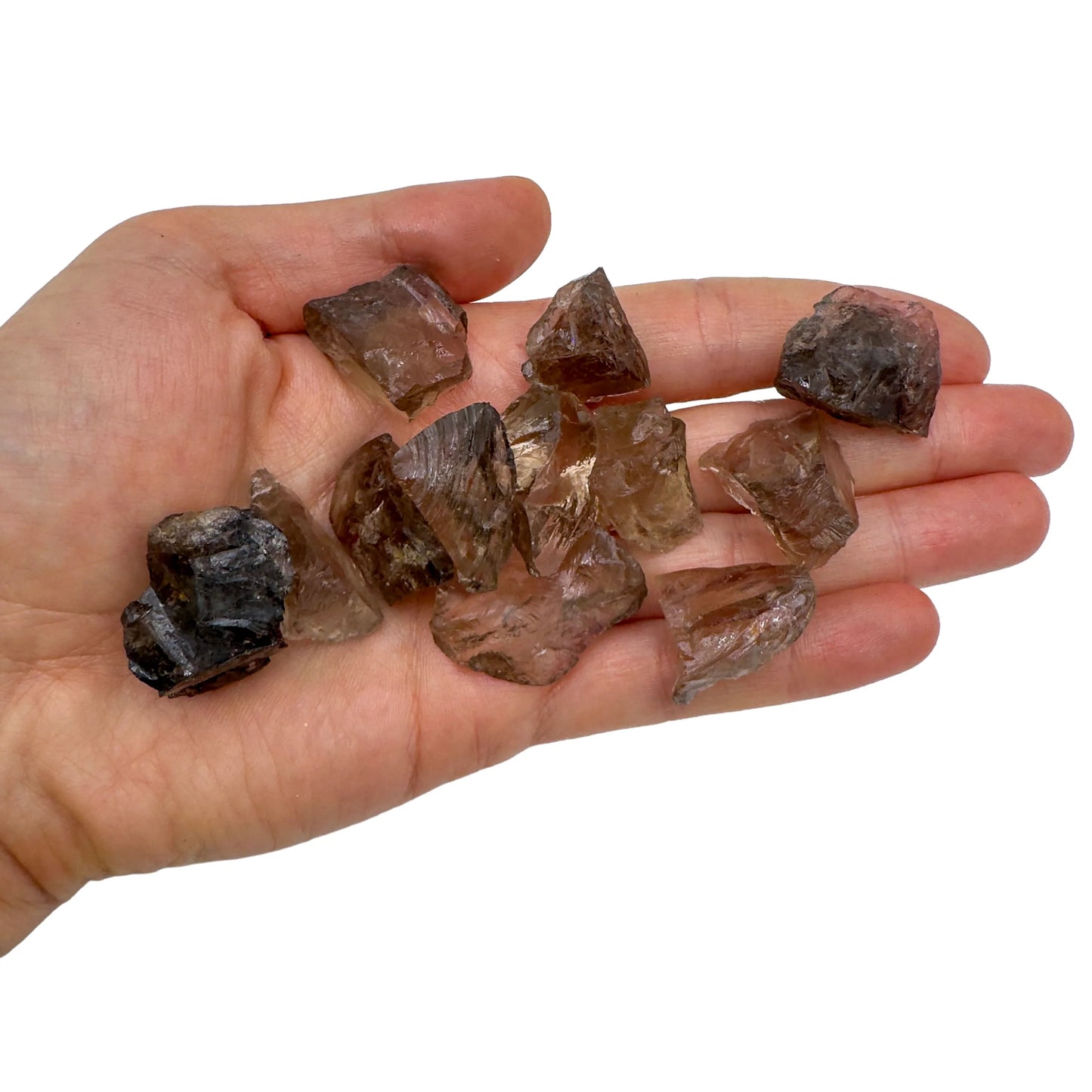 Hand holding small smoky quartz raw crystals 5-10 grams Brazil scale reference