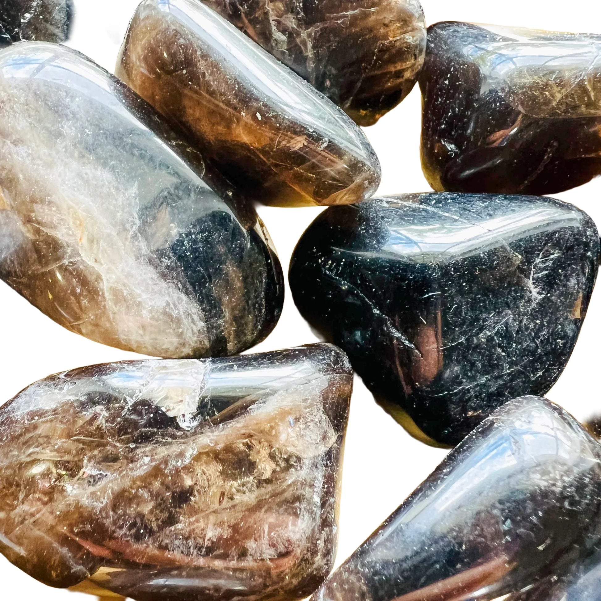 Scale reference of one Smoky Quartz tumbled stone for scale, Madagascar-sourced, sourced from Madagascar.