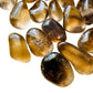 Detail capture of brown Smoky Quartz tumbled stone, showing natural inclusions, kept close for Grounding.