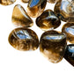 Close detail of Smoky Quartz tumbled stone, kept close for Grounding and Protection, sourced from Brazil.