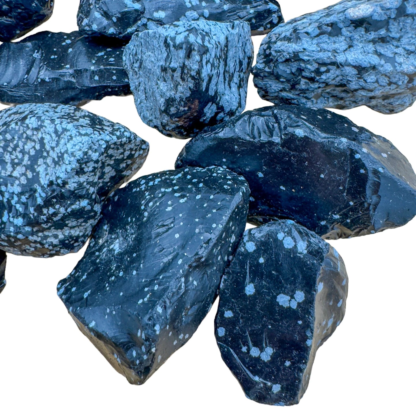 Side-on view of Snowflake Obsidian raw stone, showing natural sheen, traditionally used for Grounding and Emotional Healing.