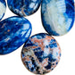 Bottom side of Grade AA Sodalite palm stone, often kept for Focus and Intuition, Namibia-sourced.