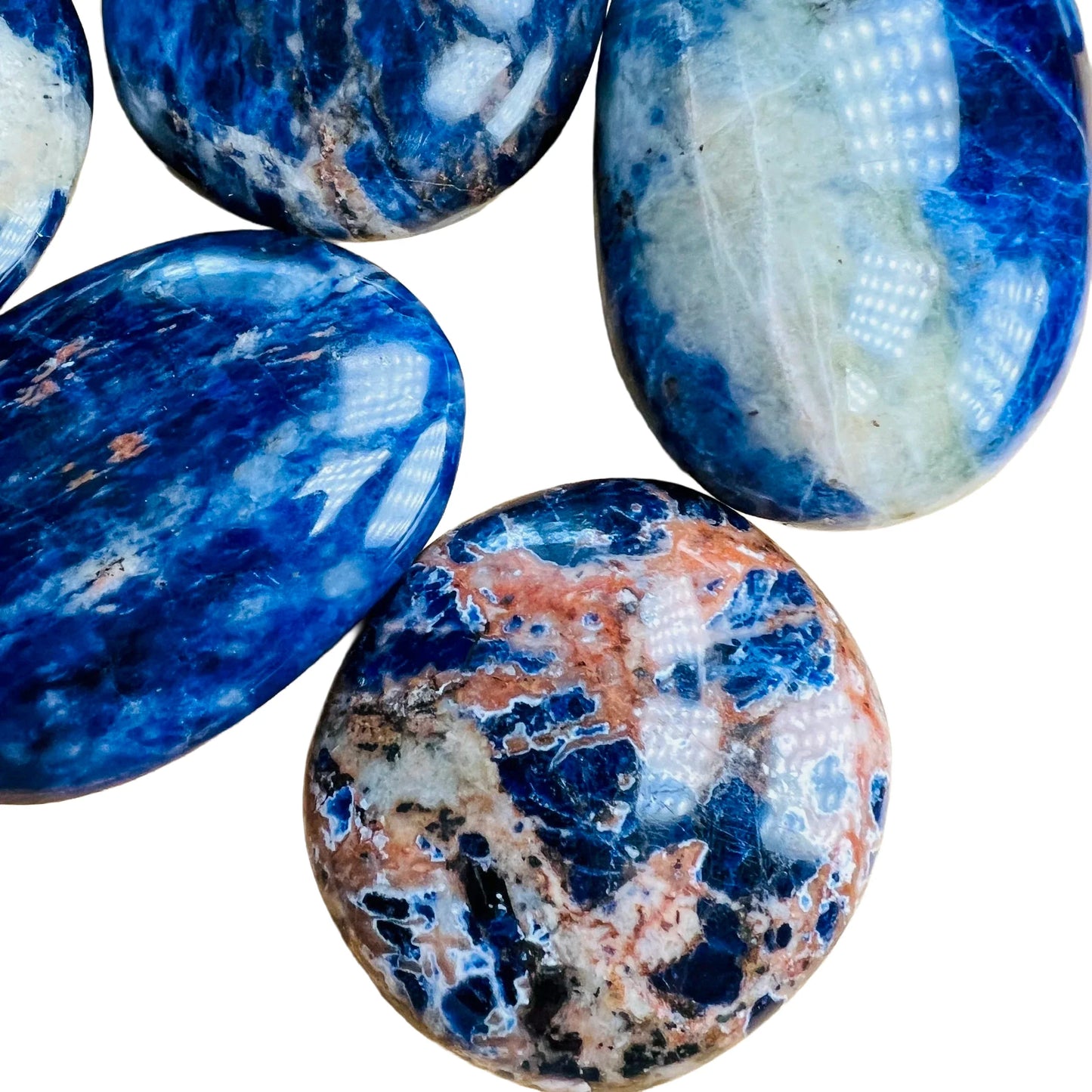 Bottom side of Grade AA Sodalite palm stone, often kept for Focus and Intuition, Namibia-sourced.