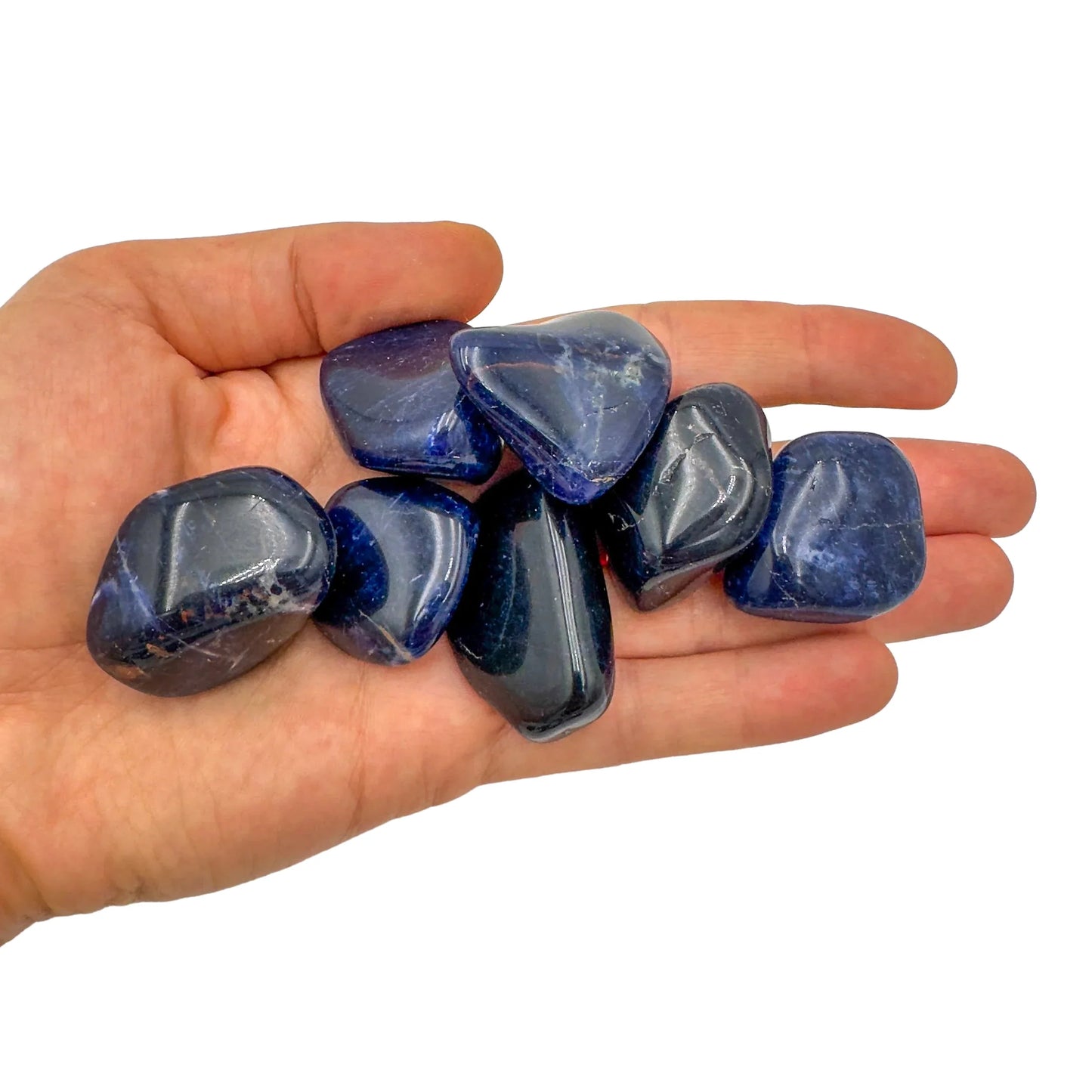 Lifestyle still of Sodalite tumbled stone, from Kunene, Namibia, showing the full body of the piece.
