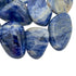 Sideways view of Sodalite tumbled stone, traditionally used for Focus and Intuition.