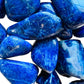 Top-down shot of Sodalite tumbled stone, showing color depth, from Namibia.