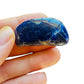 Detail shot of Grade AA Sodalite tumbled stone under natural light