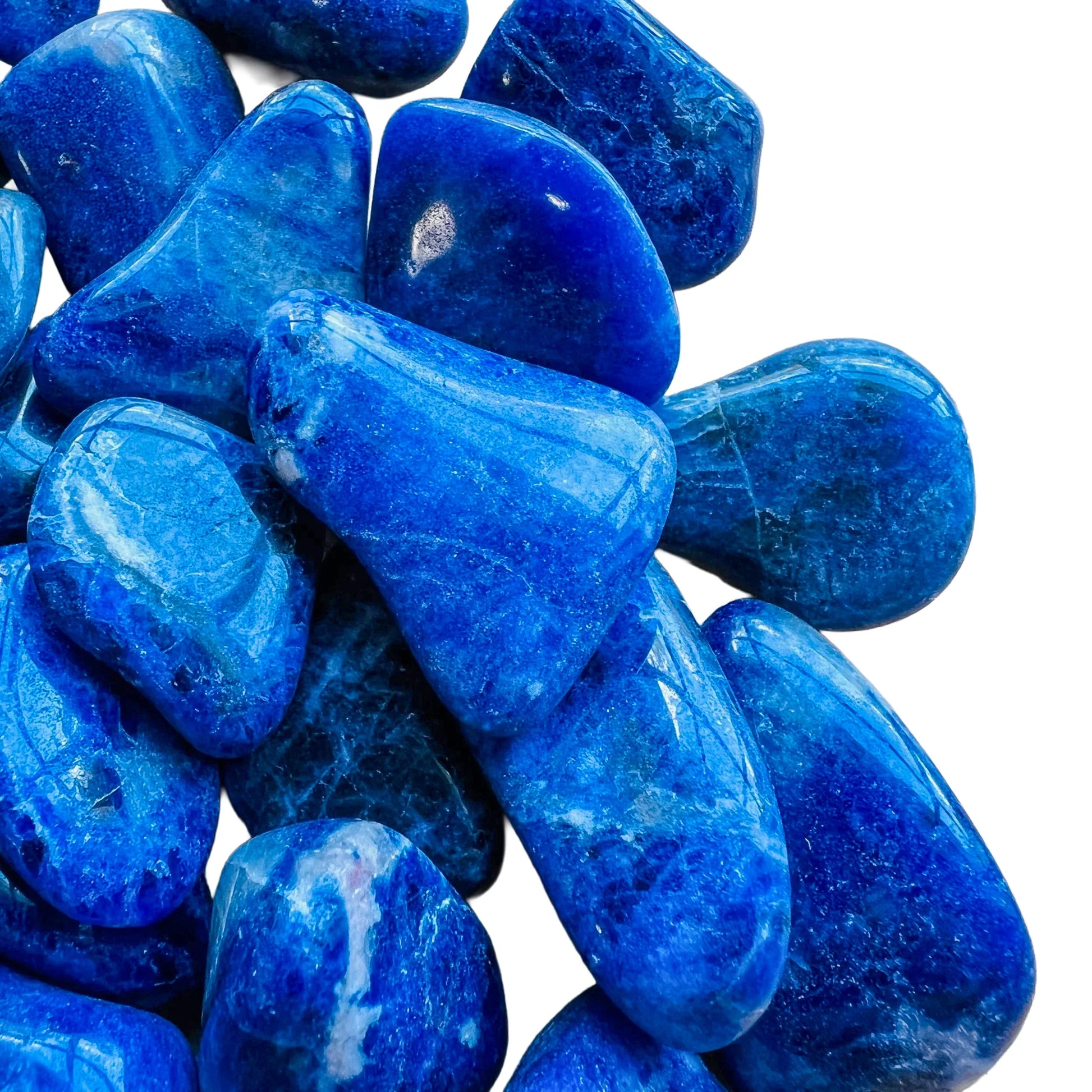 Held in hand, a Sodalite tumbled stone, from Bahia, Brazil.