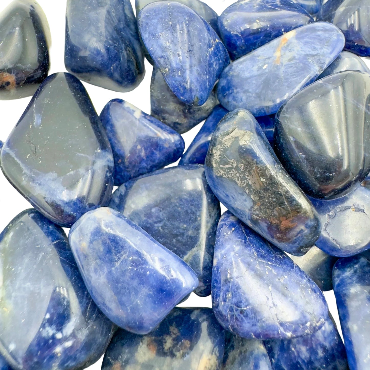 Palm-scale view of a single Sodalite tumbled stone sourced from Kunene, Namibia.