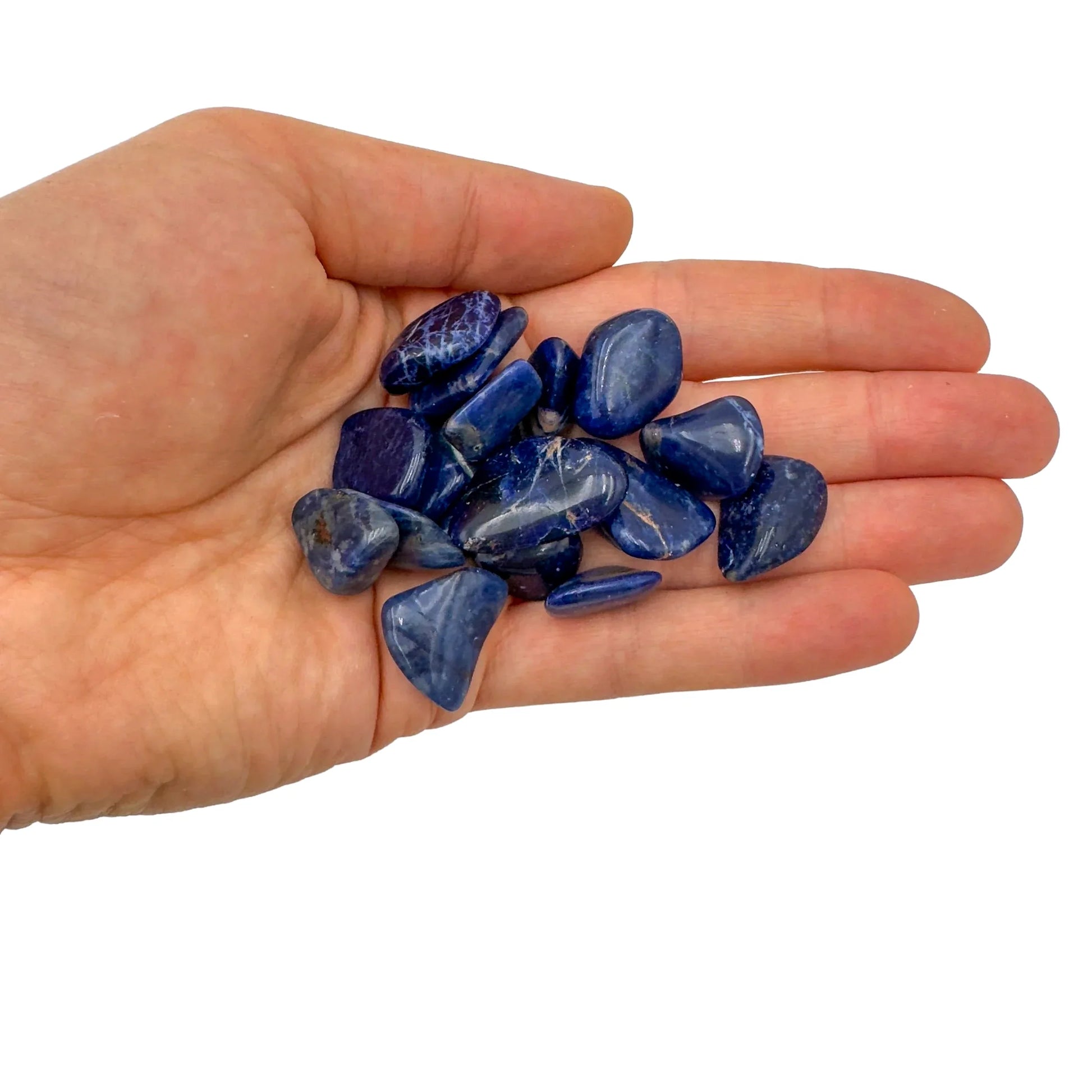 Display context of Sodalite tumbled stone, with hand-sized presence.