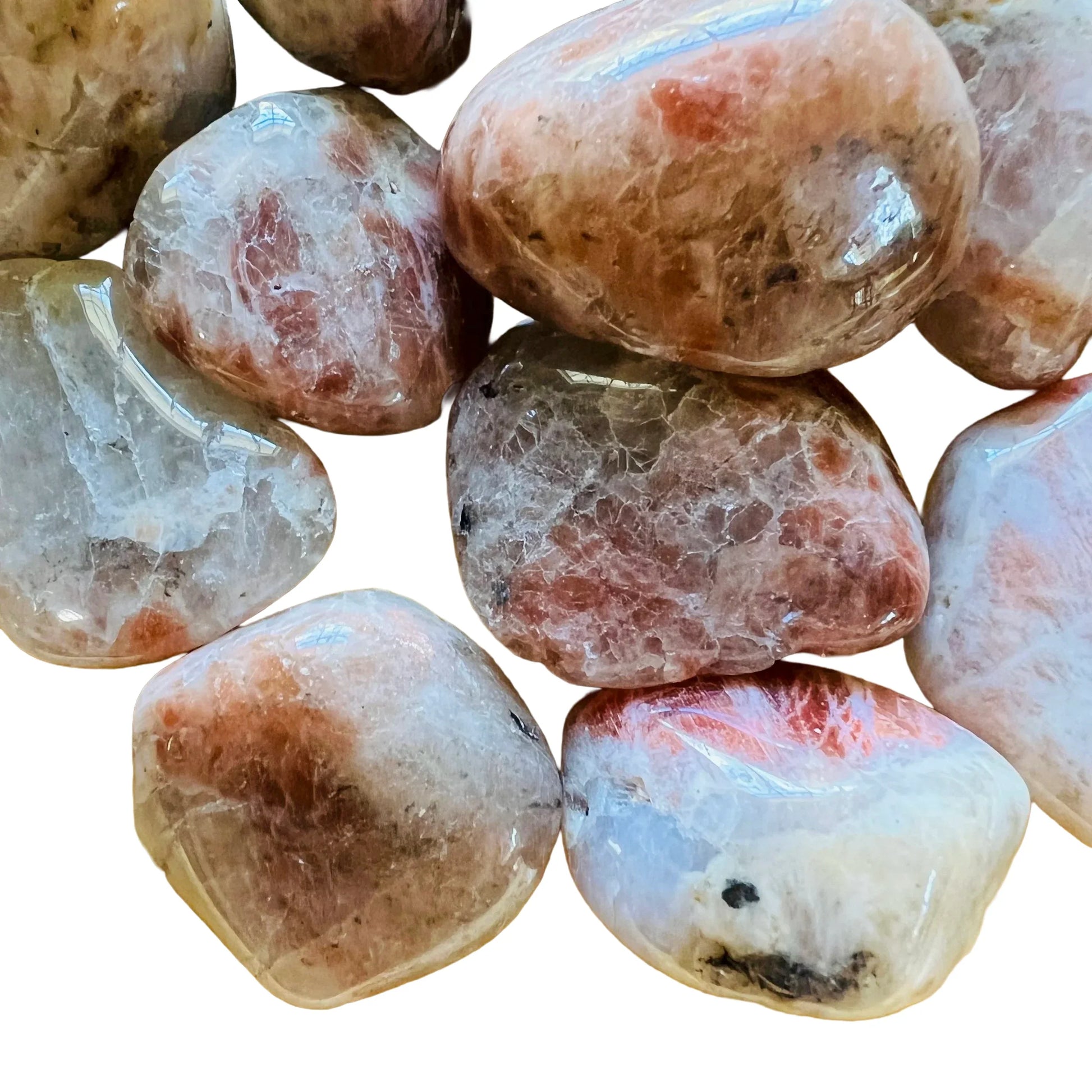 Sideways view of Grade AA Sunstone tumbled stone, from Morogoro, Tanzania, showing translucent edges.