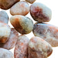 Daylight view of a single Sunstone tumbled stone from Tanzania.