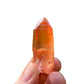 Close-up of Tangerine Quartz raw point, showing honest grain, from Brazil.