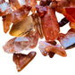 Profile view of Tangerine Quartz raw point, showing honest grain, sourced from Brazil.