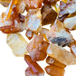 Detail shot of Grade AA Tangerine Quartz point under natural light