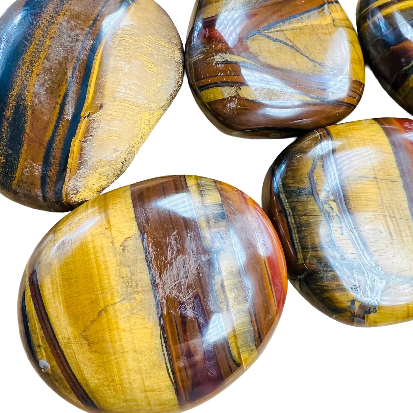 Close detail of brown Tiger Eye palm stone, often kept for Confidence and Career.
