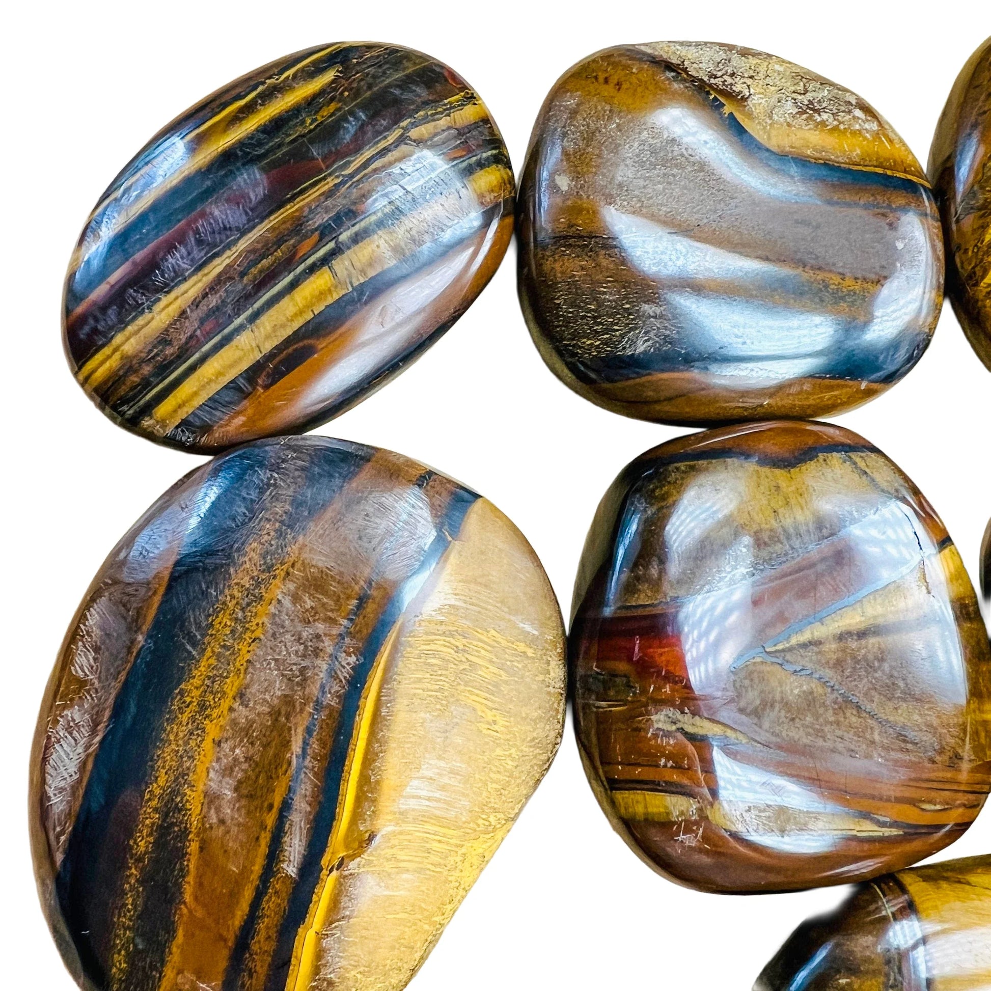 Side-on view of Grade AA Tiger Eye palm stone, kept near for Confidence, South Africa-sourced.