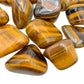 Side profile of Tiger Eye tumbled stone, sourced from Northern Cape, South Africa, worked with for Confidence.