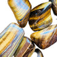 Full profile of Grade A Tiger Eye tumbled stone ready to ship from Beyond Bohemian