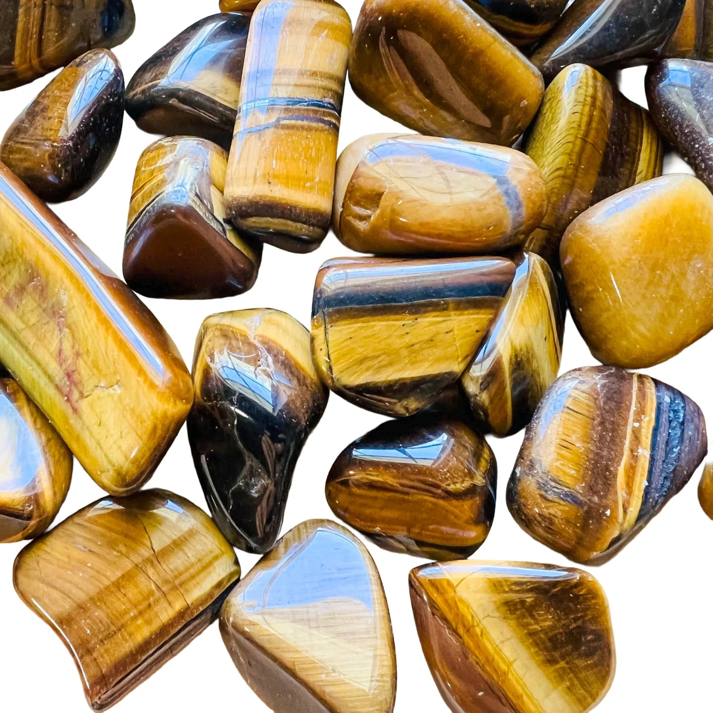 Detail shot of Grade A Tiger Eye tumbled stone under natural light