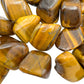 Looking down on Tiger Eye tumbled stone, associated with Confidence and Career, sourced from Northern Cape, South Africa.