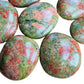 Top-down shot of Unakite palm stone, showing natural inclusions, sourced from South Africa.