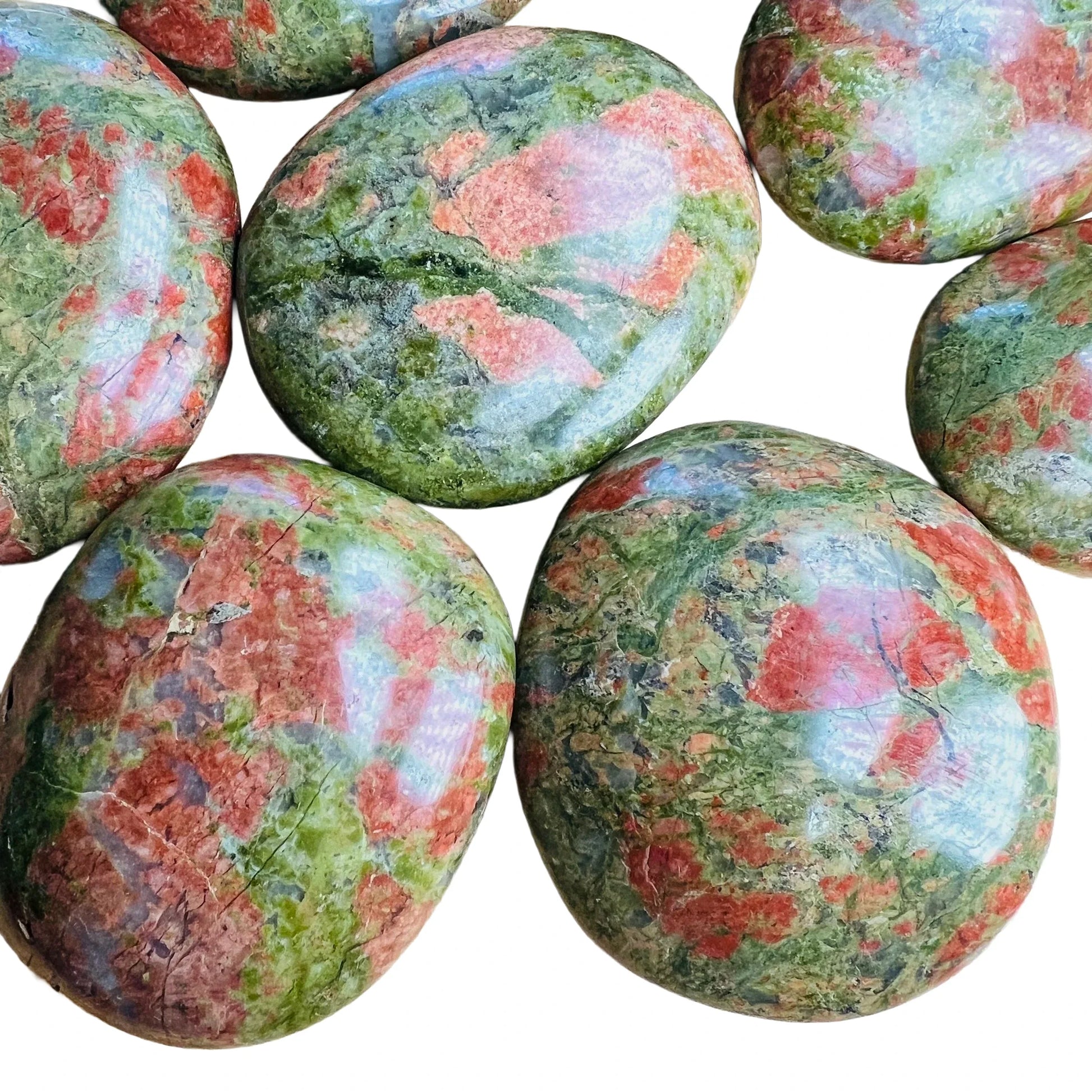 Top-down shot of Unakite palm stone, showing natural inclusions, sourced from South Africa.